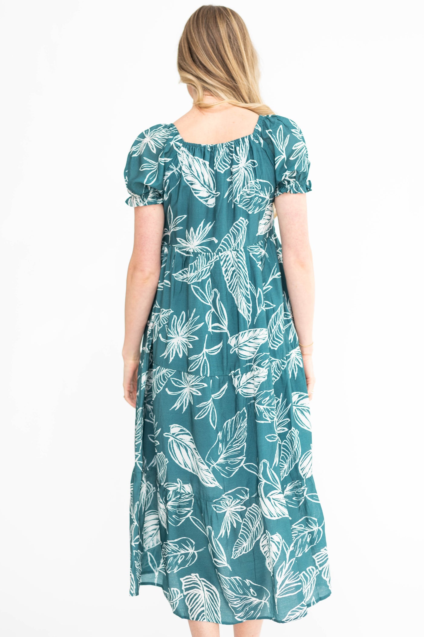 Back view of a short sleeve teal floral dress