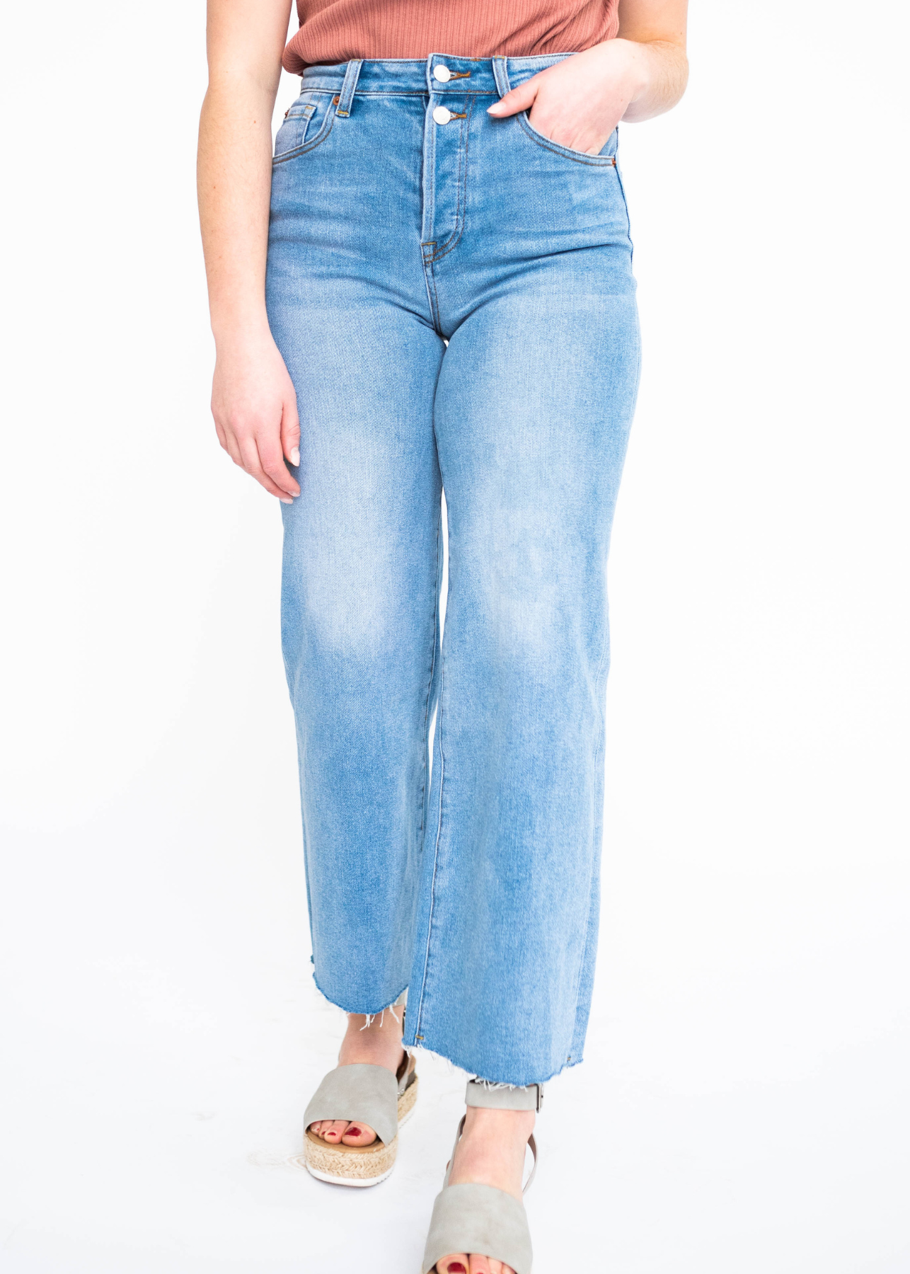Wide leg light indigo jeans with faded marks on the legs