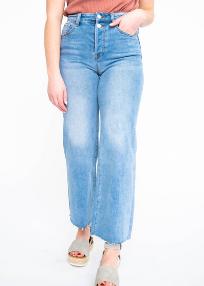 Wide leg light indigo jeans with faded marks on the legs